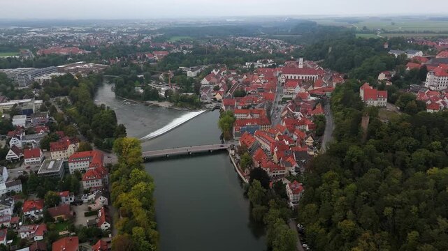 Aerial panorama of Landsberg am Lech Germany featuring the Karolinenwehr, the river bridge and the traditional Bavarian old town. The fall season adds warm tones to the European cityscape.