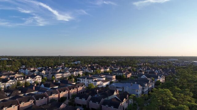 Aerial view of luxury houses in Houston, Woodlands by the lake with dramatic cloudy sky in Texas, United States