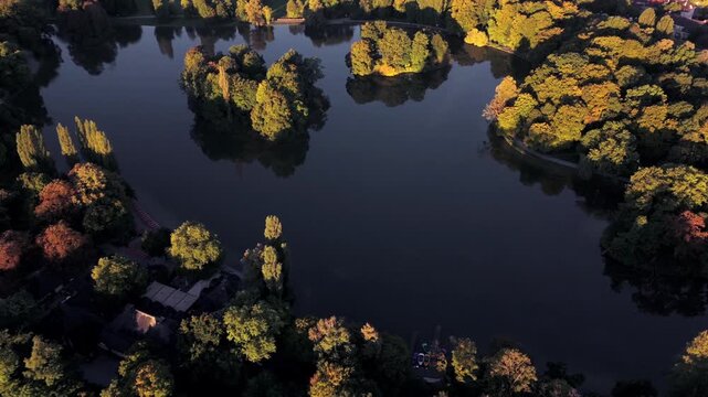 Top view of the English Garden with Kleinhesseloher See, Seehaus Munich, Schwabing and Isar. Scenic landscape of Bavaria, Germany. Wide panorama of the largest park in Munich