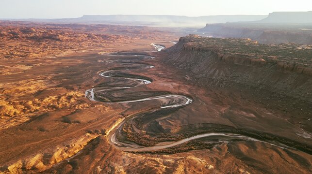 Serpentine River Through Majestic Desert Canyon Landscape at Sunset.