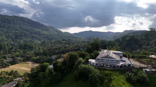 Aerial Tea Factory Surrounded By Sinharaja Forest Mountains Sri Lanka
Aerial drone footage above tea factory near Sinharaja rainforest mountains in Sri Lanka May 2026.
