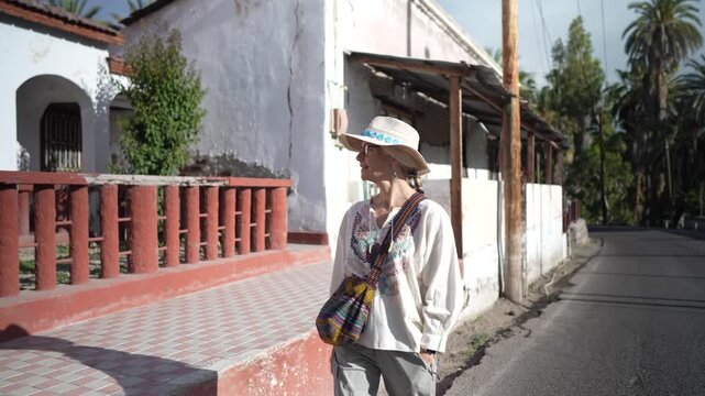 Mature woman enjoys a walk around the streets of San Ignacio, Baja California Sur Mexico, discovering the Mission and local culture.