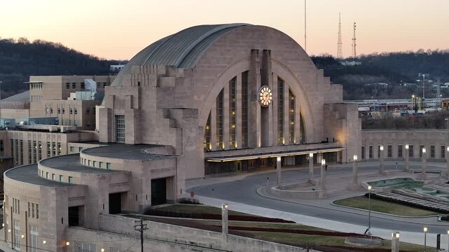 Aerial view of Cincinnati Union Terminal featuring its iconic Art Deco architecture and large clock under a soft twilight sky in Cincinnati, Ohio, United States.