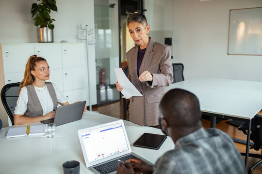 Manager leading team discussion in modern office