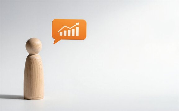 Wooden figure gazes at orange speech bubble with upward trending