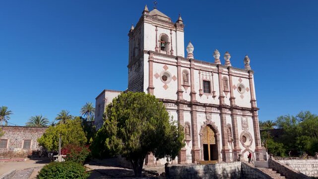 Aerial views showcase the Mission Church in San Ignacio, a historical landmark in Baja California surrounded by desert scenery.
