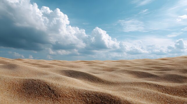 Dramatic contrast between rippled sand dunes and expansive cloudy blue sky