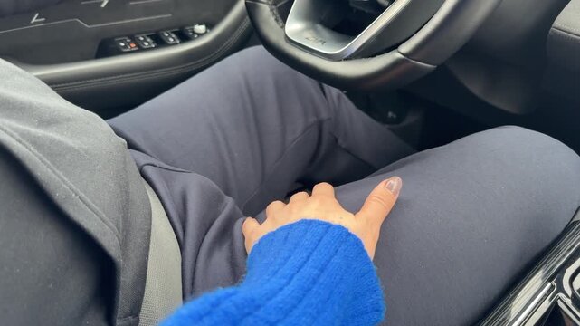  Couple in car: supportive touch on thigh, seat belt visible, UHD