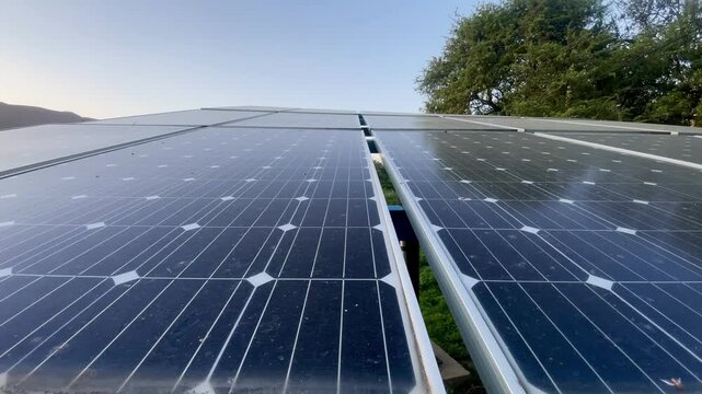 Close‑up view of solar panel cells, capturing clean energy with sleek reflective surfaces under sunlight.