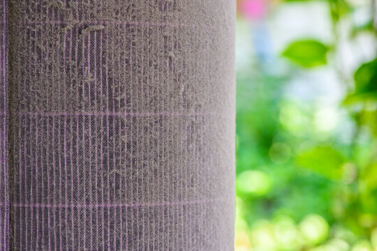 Dusty Air Conditioner Filter Close Up with Nature Background PM2.5 concept