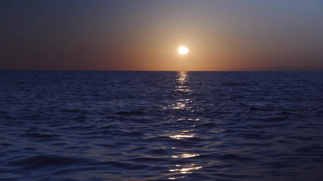 Ocean sunset serenity golden sun reflection on calm blue water horizon view peaceful evening seascape nature tranquility sky light sea