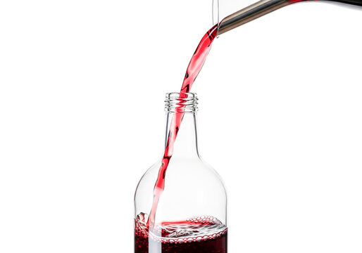 Red wine pouring from bottle into glass