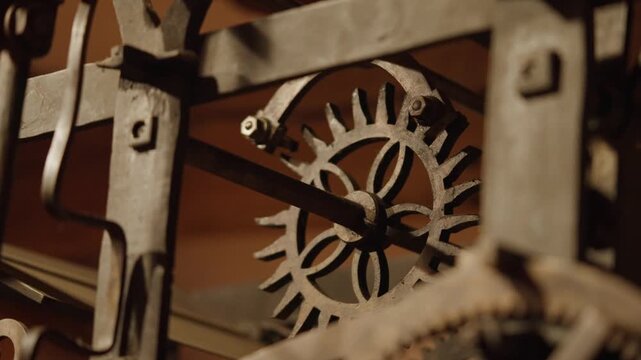 A close-up shot of the mechanical gears of a grand clock inside a German castle, swinging back and forth
