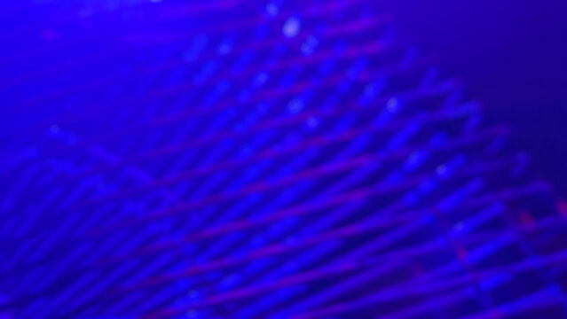 Abstract blue background texture with parallel moving red and purple light lines creating a dynamic electronic pattern and digital data technology concept