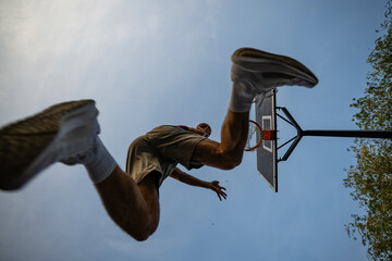 Basketball player jumping for a dynamic slam dunk © Zoran Jesic