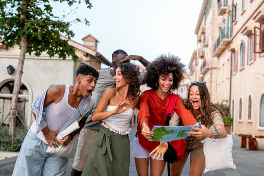 Diverse group of friends celebrates joy and togetherness while traveling, expressing pure happiness