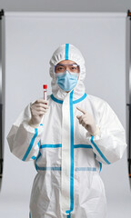 Fototapeta premium medical professional full protective gear gloves mask standing centered front white studio backdrop holding test tube