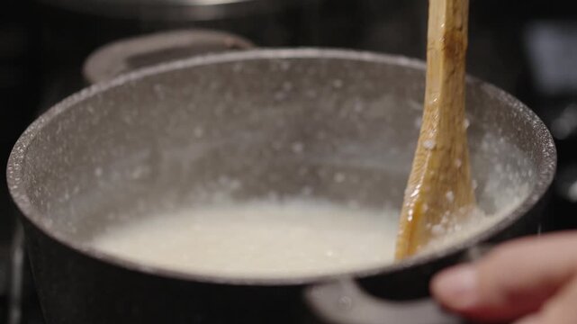 Cooking ghomi, a popular dish from the Samegrelo region made with coarse white corn flour
