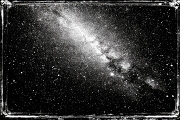 Fototapeta premium Starry night sky with Milky Way band on black background and distressed frame texture border