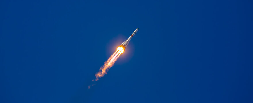 Take-off of a real launch vehicle from a spaceport. A rocket takes off into the sky against a background of clouds. Startup concept, power of science and technology.