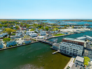 Fototapeta premium Mystic River Bascule Bridge aerial view, a high-angle drone shot showing cars crossing the iconic drawbridge next to downtown storefronts and the waterfront on a bright spring day.