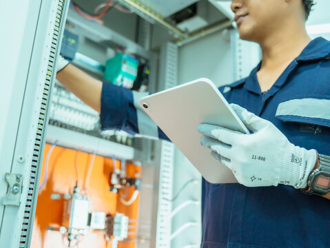 
Professional engineer using digital tablet analysis management continuous emission  monitoring system in factory and industry. Business air pollution reduction, sustainable environment protection.
