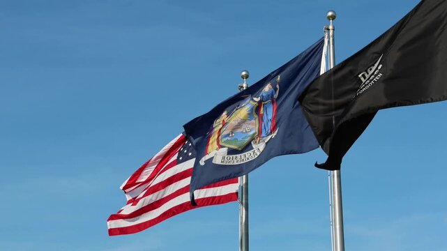 flag of united states of america and the state of new york wave in breeze at public park travel nyc ny usa us