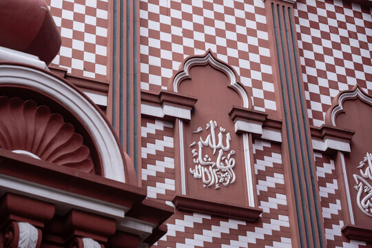 Islamic calligraphy and checkered patterns on the Red Mosque in Colombo, Sri Lanka. Architectural detail of Jami Ul-Alfar.