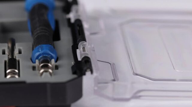 A set of tools with bits in a plastic case.