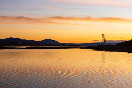 Sunrise view of the St. Lawrence River between the Island of Orleans and the north coast, with the Laurentian mountains in background silhouette,&nbsp;St. Pierre, Island of Orleans, Quebec, Canada