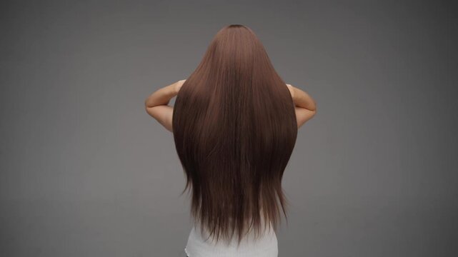 Woman Flipping Long Straight Brown Hair from Back View