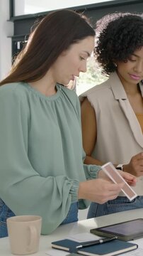 Vertical video: Sorting woman in mint top tapping tablet, giving card at bar for decor pal pointing