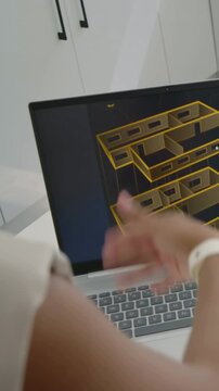 Vertical video: Woman in blazer seeing 3D plan on laptop leaning at desk, tuning model, copy space