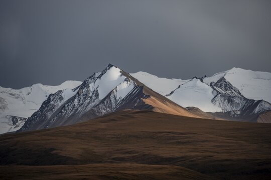 Glaciated and snow-capped mountains, dramatic landscape, high plateau, autumnal mountain landscape with yellow grass, Tian Shan, Sky Mountains, Sary Jaz Valley, Kyrgyzstan