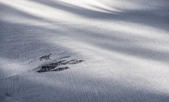 Rocks looking out from the snow cover of the glacier, Glacier du Tour, High Alpine landscape, Chamonix, Haute-Savoie, France