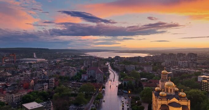 Cityscape aerial panorama view of Varna city center and the Cathedral of the Assumption with scenic sunset sky clouds