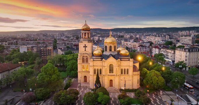Cityscape aerial panorama view of Varna city center and the Cathedral of the Assumption with scenic sunset sky clouds