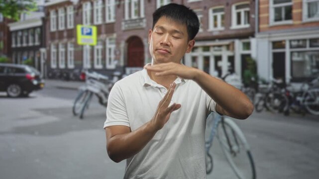 Man makes timeout gesture with hands on a bike lined urban street in front of brick buildings and parked bicycles; thoughtful pause.