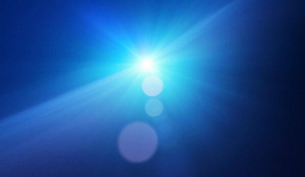 Abstract blue light flare and lens flares moving across a dark background with cinematic motion