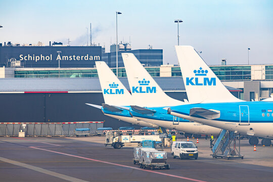 Amsterdam, Netherlands - 22.01.2026: Row of KLM Royal Dutch Airlines tails at the terminal gates with Schiphol Amsterdam sign in the background