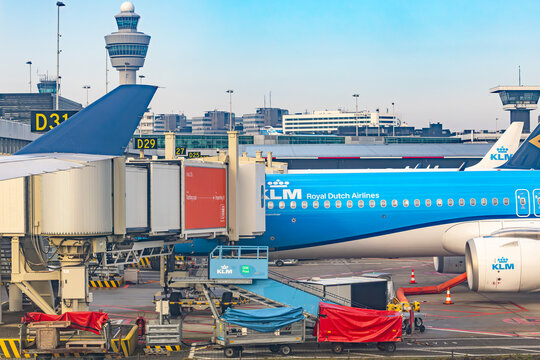 Amsterdam, Netherlands - 22.01.2026: KLM Royal Dutch Airlines airplane being serviced at the terminal gate and control tower at Schiphol Airport