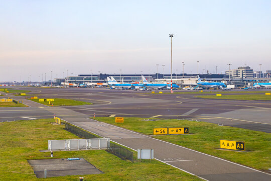 Amsterdam, Netherlands - 22.01.2026: Runway and taxiway system with navigation signs at Amsterdam Schiphol Airport with KLM airplanes