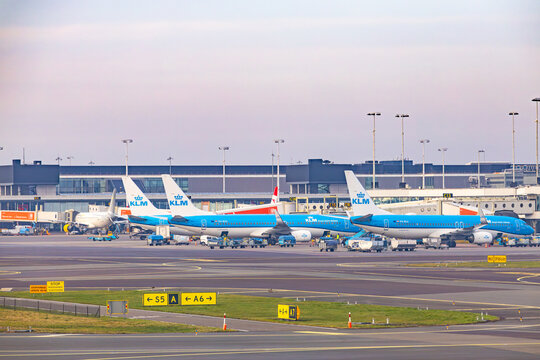 Amsterdam, Netherlands - 22.01.2026: KLM Royal Dutch Airlines airplanes at the terminal gates with yellow taxiway signs at Amsterdam Schiphol Airport