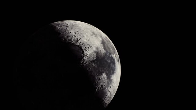 A stunning crescent moon showcases its craters and surface texture brightly contrasted against the deep darkness of the night sky, creating a mesmerizing celestial view.
