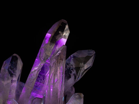 Abstract glowing quartz crystal illuminated by ultraviolet light