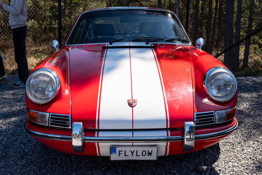 Djurhamn, Sweden - May 10, 2026: Red striped 1968 Porsche 911 Classic as seen at car exhibition