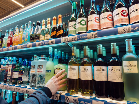 05.12.2026, Zory, Poland. Customer choosing alcohol in Auchan supermarket