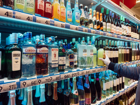 05.12.2026, Zory, Poland. Customer choosing alcohol in Auchan supermarket