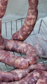 Close up of uncooked raw sausage showcasing its juicy texture, ideal for flavorful dishes and culinary creativity. black background. top view. High quality 4k footage