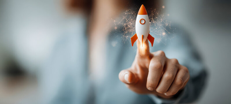 Hand pressing a button to launch a rocket with digital effects in a modern indoor setting